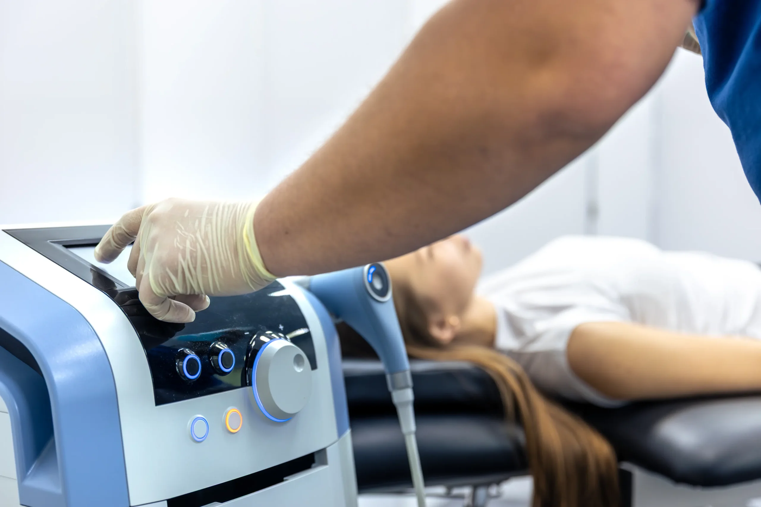 Chiropractor performing shockwave therapy on patient in Tampa